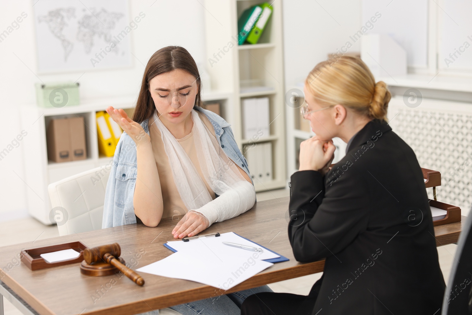 Photo of Injured woman having meeting with lawyer in office