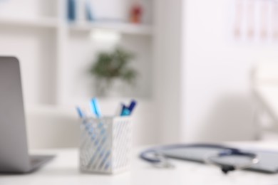 Photo of Blurred view of doctor's workplace in medical office, closeup