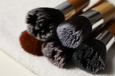 Photo of Clean makeup brushes on table, closeup view