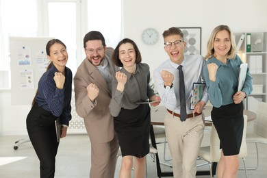 Portrait of happy coworkers in formal clothes indoors