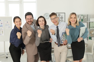 Portrait of happy coworkers in formal clothes indoors