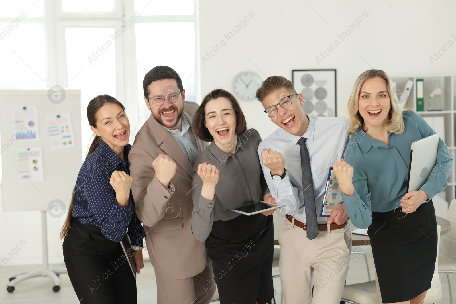 Photo of Portrait of happy coworkers in formal clothes indoors