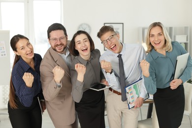 Photo of Portrait of happy coworkers in formal clothes indoors