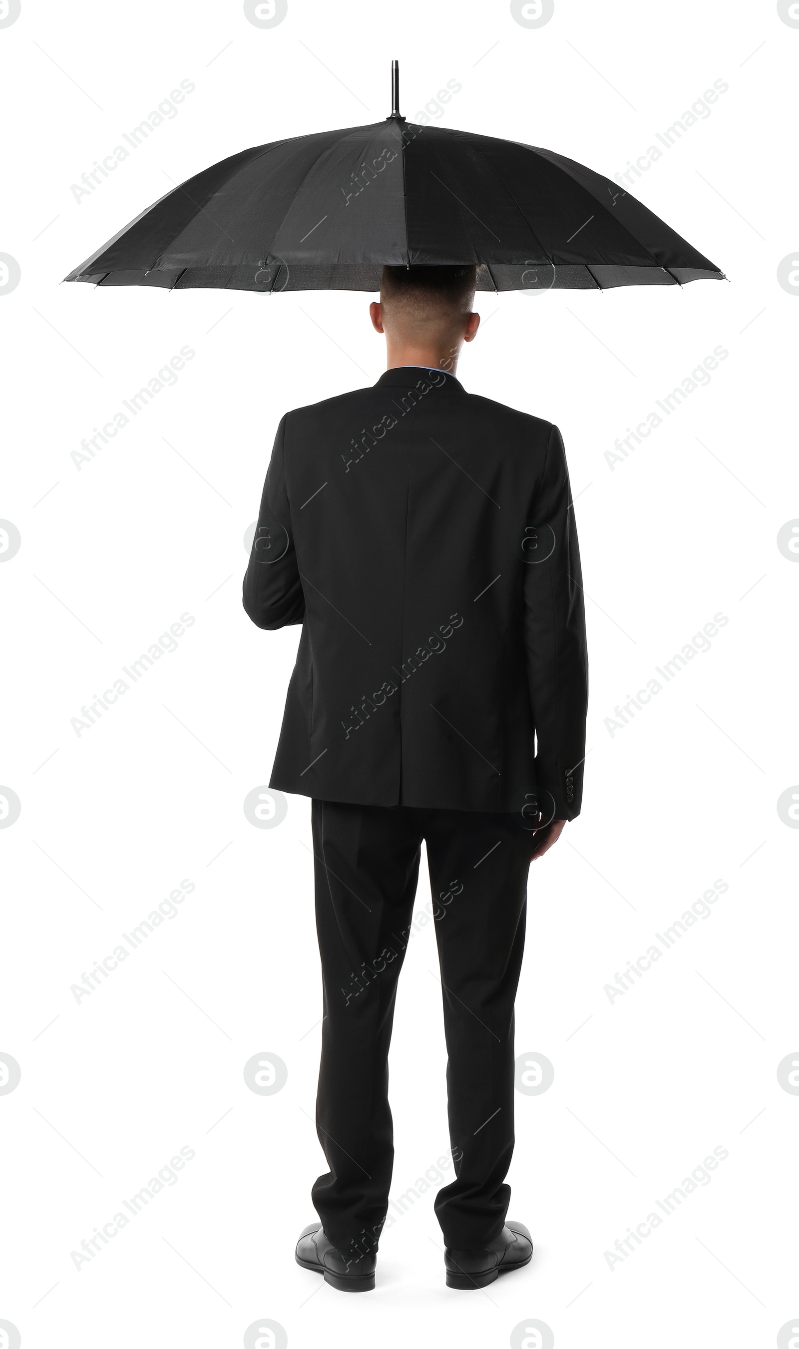 Photo of Man in suit with black umbrella on white background, back view