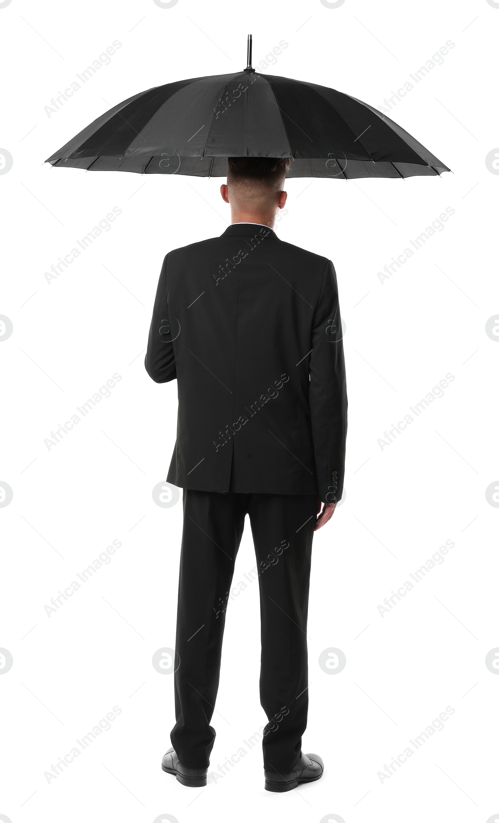 Photo of Man in suit with black umbrella on white background, back view