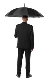 Man in suit with black umbrella on white background, back view