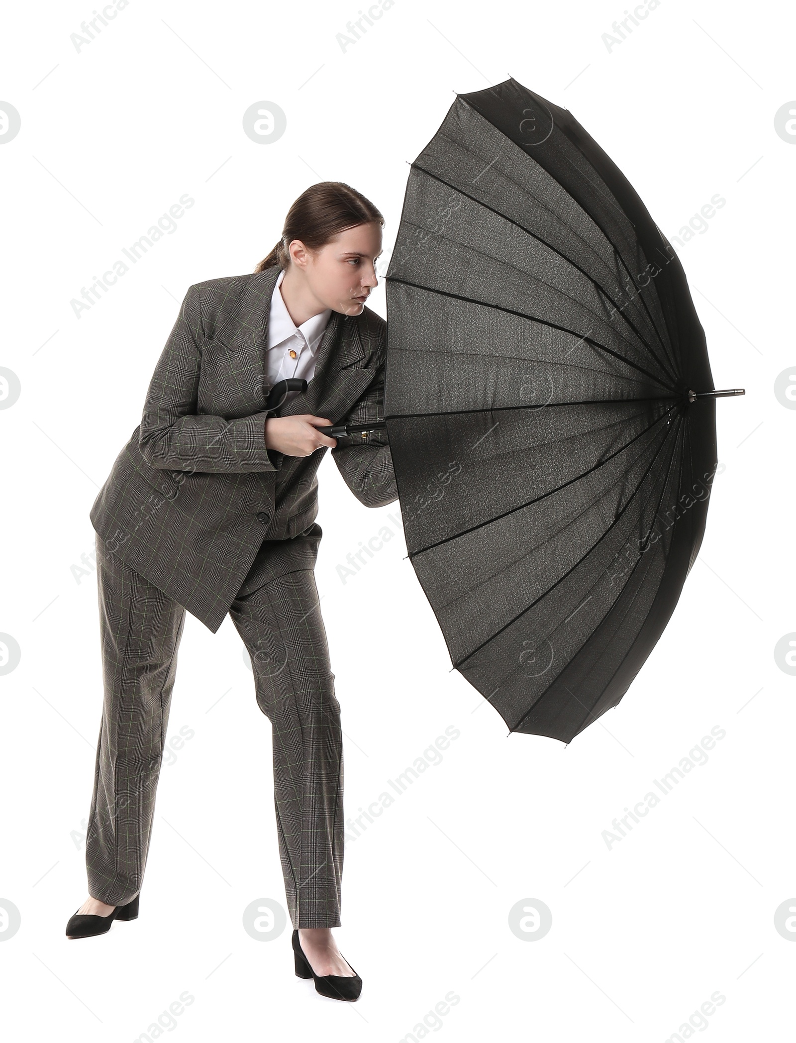 Photo of Young woman with black umbrella on white background