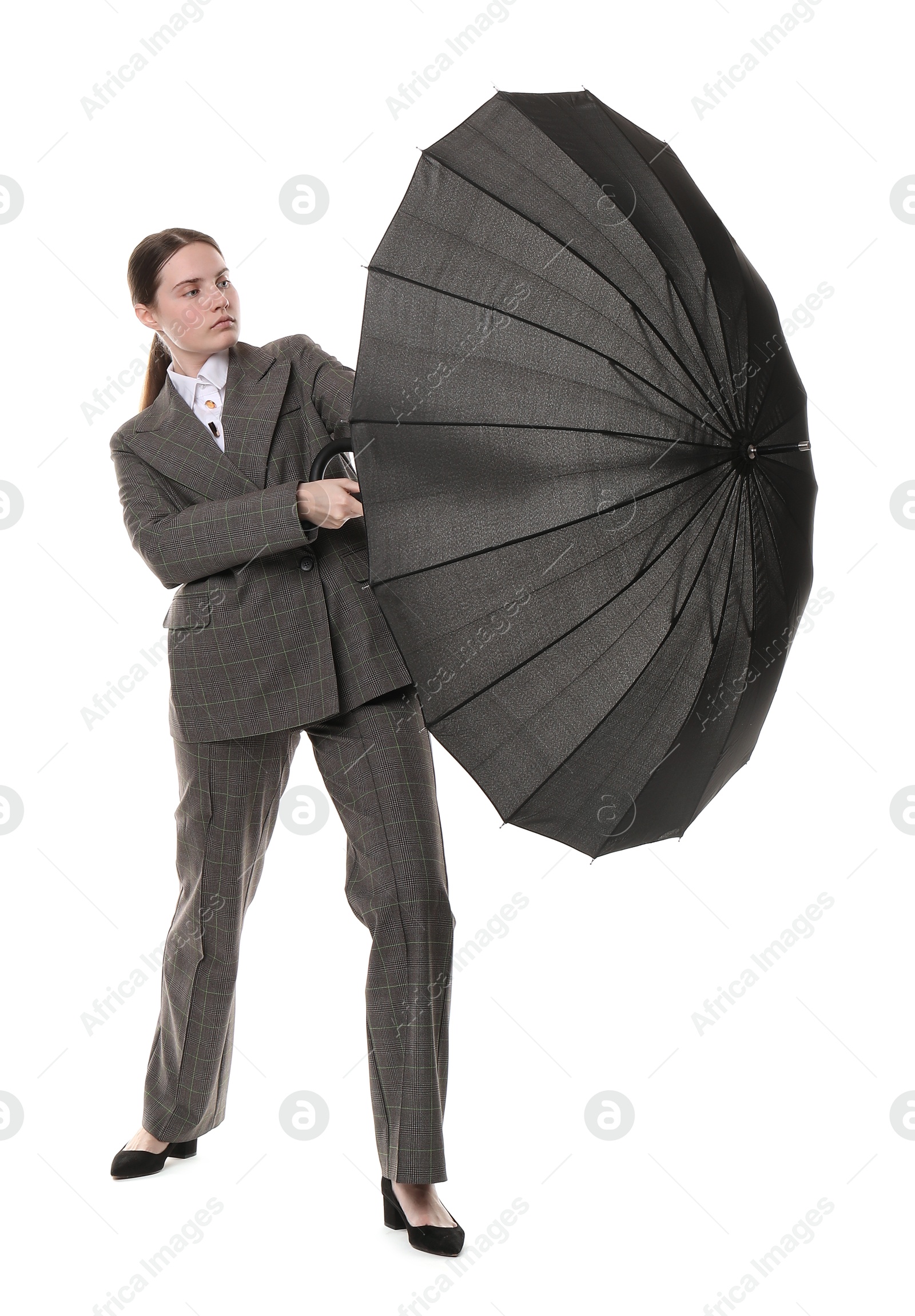 Photo of Young woman with black umbrella on white background