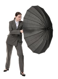 Photo of Young woman with black umbrella on white background