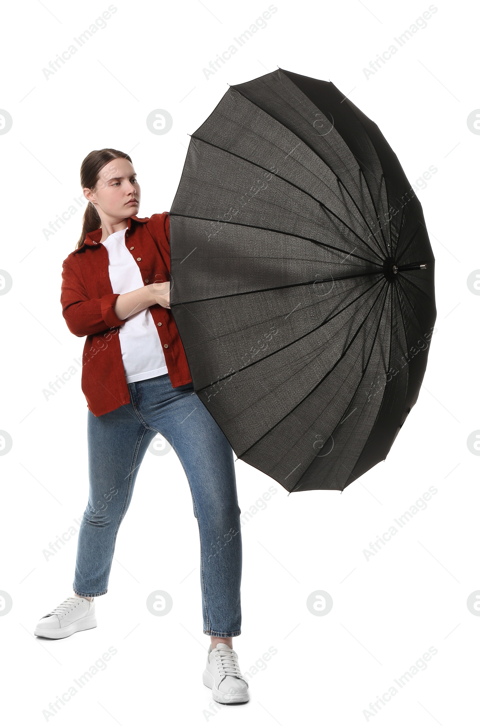 Photo of Young woman with black umbrella on white background