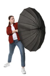 Photo of Young woman with black umbrella on white background