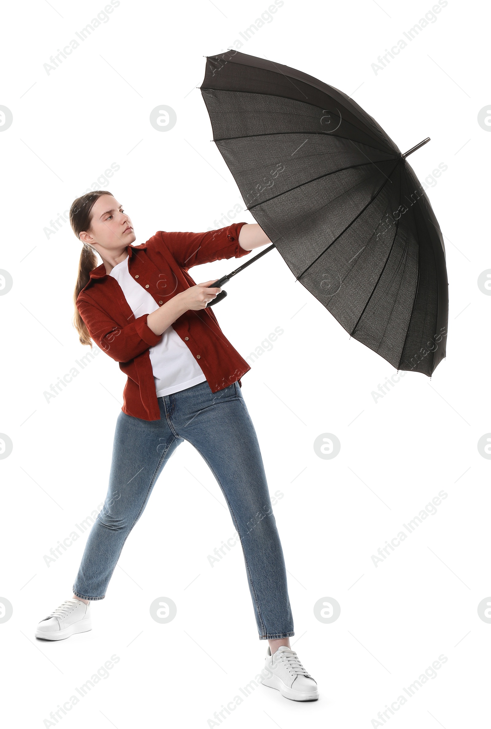 Photo of Young woman with black umbrella on white background