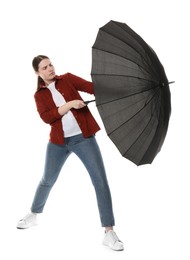 Photo of Young woman with black umbrella on white background