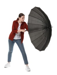 Photo of Young woman with black umbrella on white background