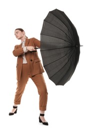 Photo of Young woman with black umbrella on white background