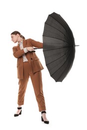 Photo of Young woman with black umbrella on white background