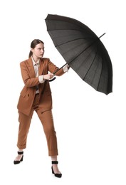 Photo of Young woman with black umbrella on white background