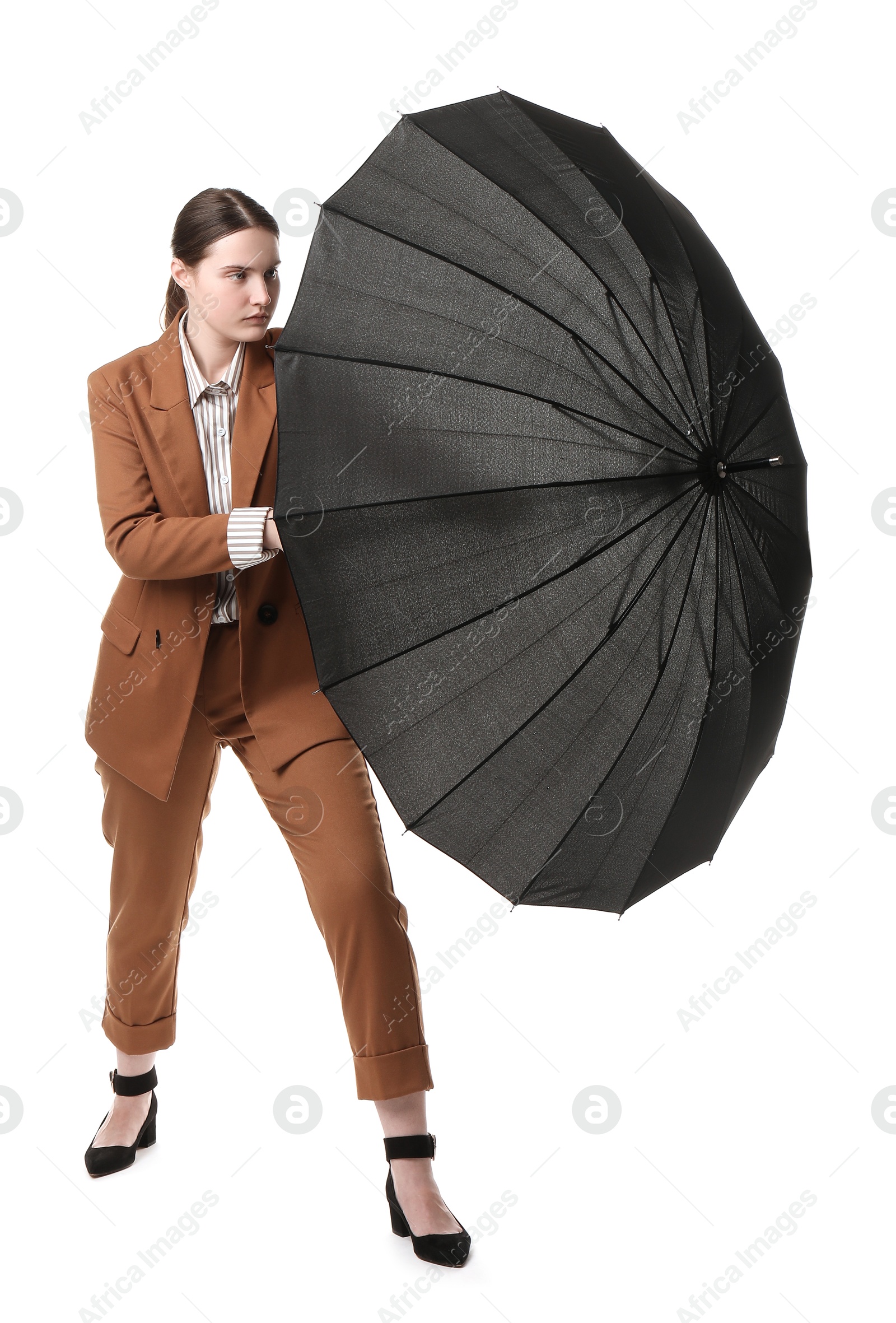 Photo of Young woman with black umbrella on white background