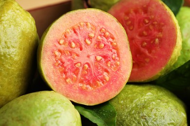 Photo of Fresh cut and whole guava fruits, closeup