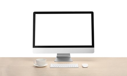 Computer monitor, keyboard, mouse and cup of drink on wooden desk against white background