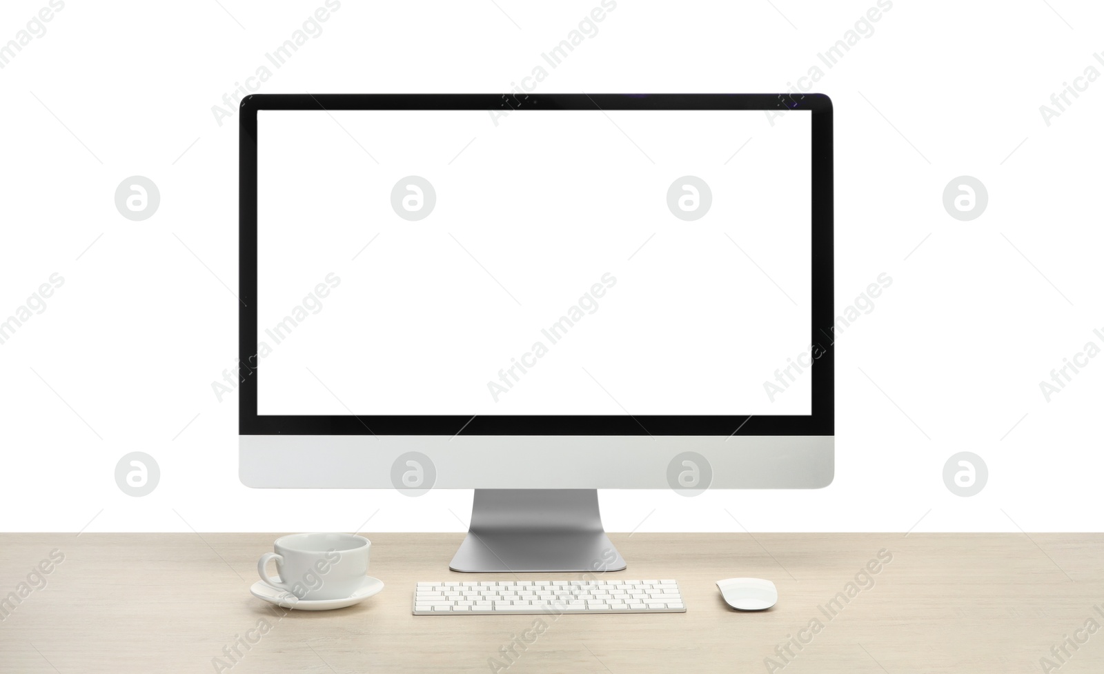 Photo of Computer monitor, keyboard, mouse and cup of drink on wooden desk against white background