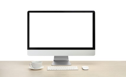 Photo of Computer monitor, keyboard, mouse and cup of drink on wooden desk against white background