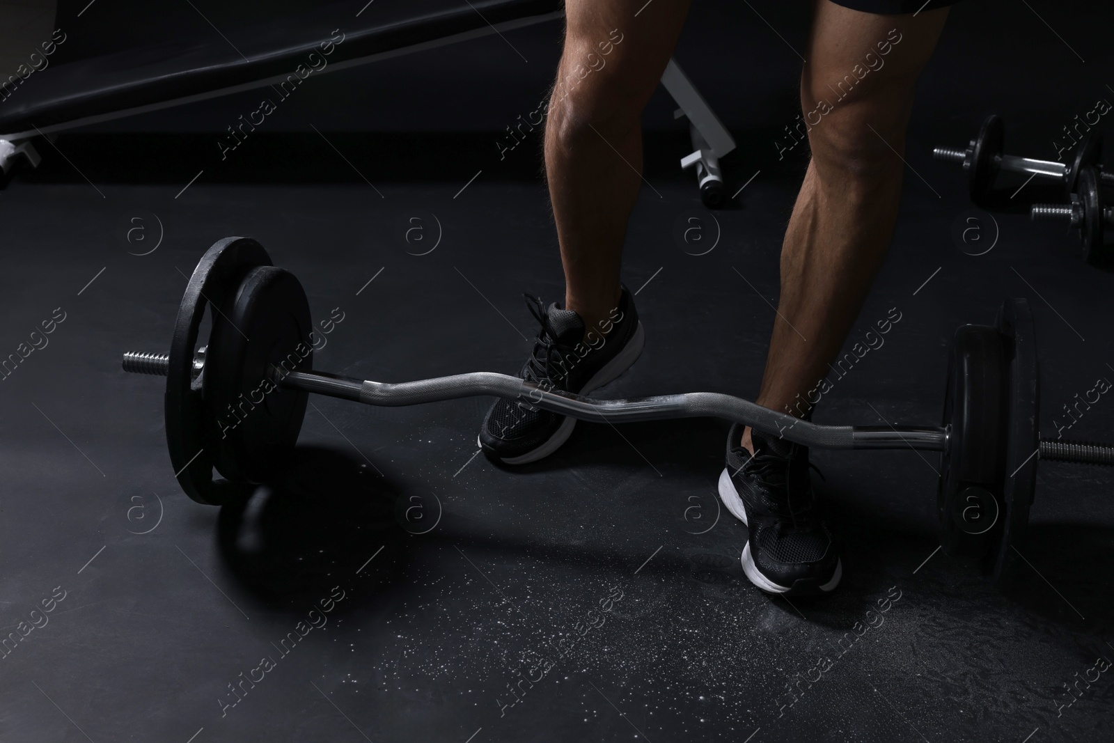 Photo of Man and sports equipment in gym, closeup