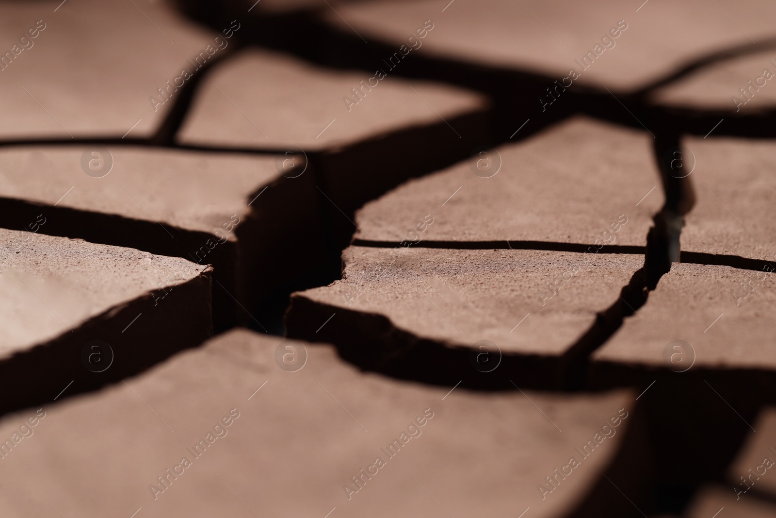 Photo of Dry cracked ground as background, closeup. Global warming