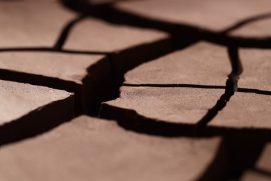 Photo of Dry cracked ground as background, closeup. Global warming