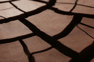 Photo of Dry cracked ground as background, closeup. Global warming