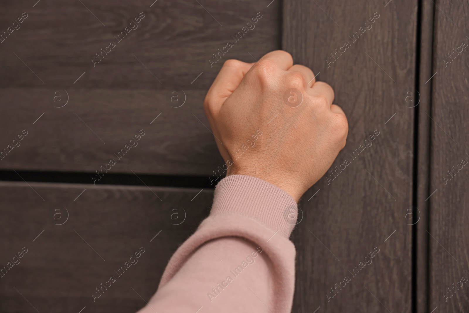 Photo of Man knocking on door to his friends apartment, closeup