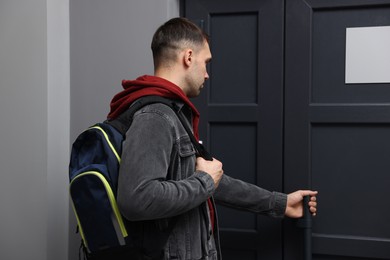 Photo of Man knocking on door of his friends apartment