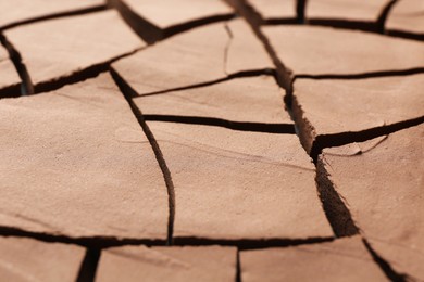 Photo of Dry cracked ground as background, closeup. Global warming