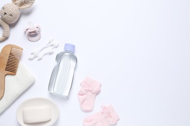 Photo of Baby oil and bath accessories on white background, flat lay. Space for text