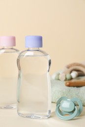 Photo of Baby oil and bath accessories on color background