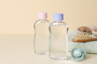 Photo of Baby oil and bath accessories on color background