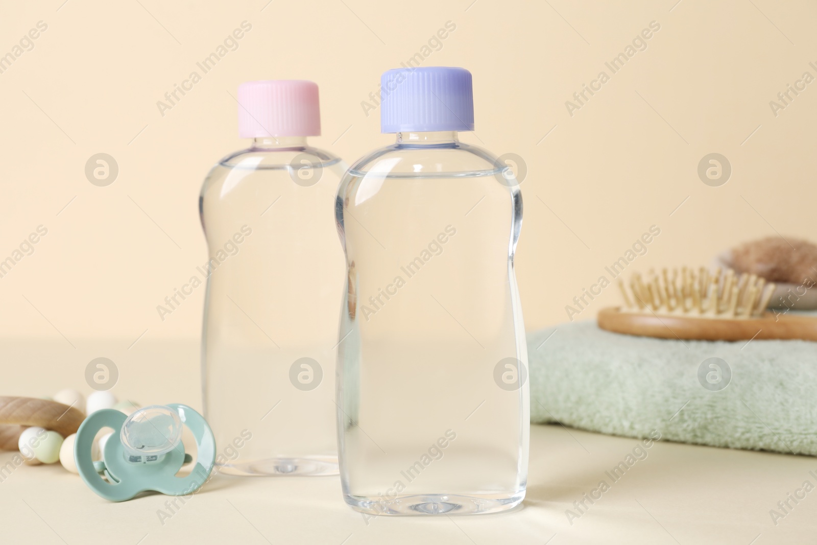 Photo of Baby oil and bath accessories on color background