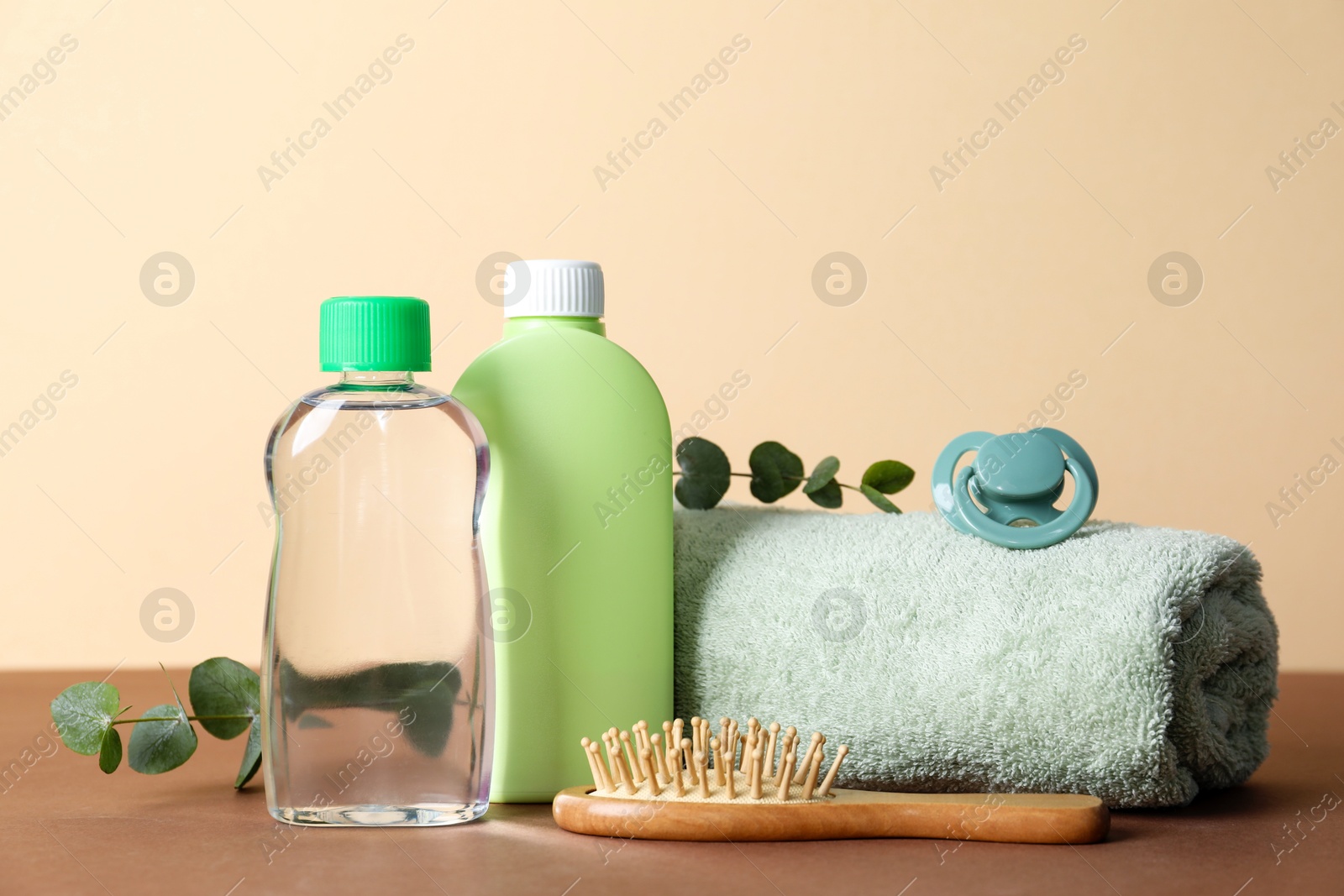 Photo of Baby oil and bath accessories on color background