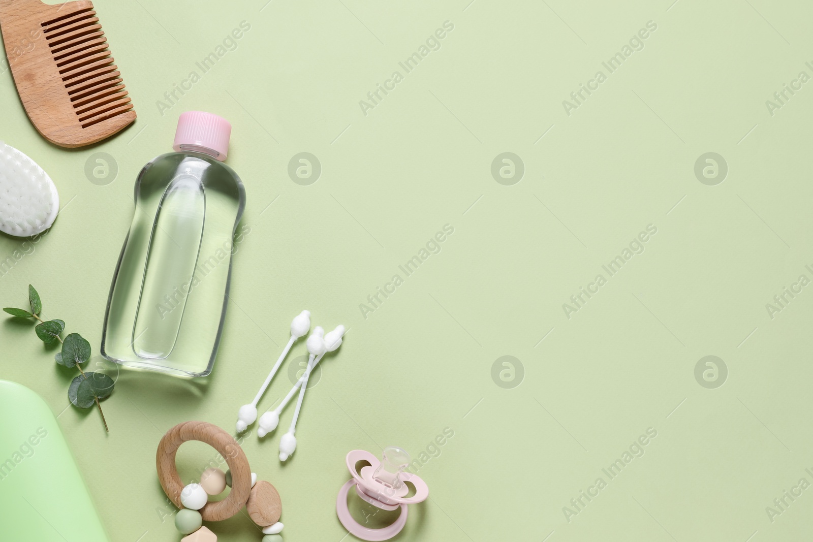 Photo of Baby oil and bath accessories on light background, flat lay. Space for text