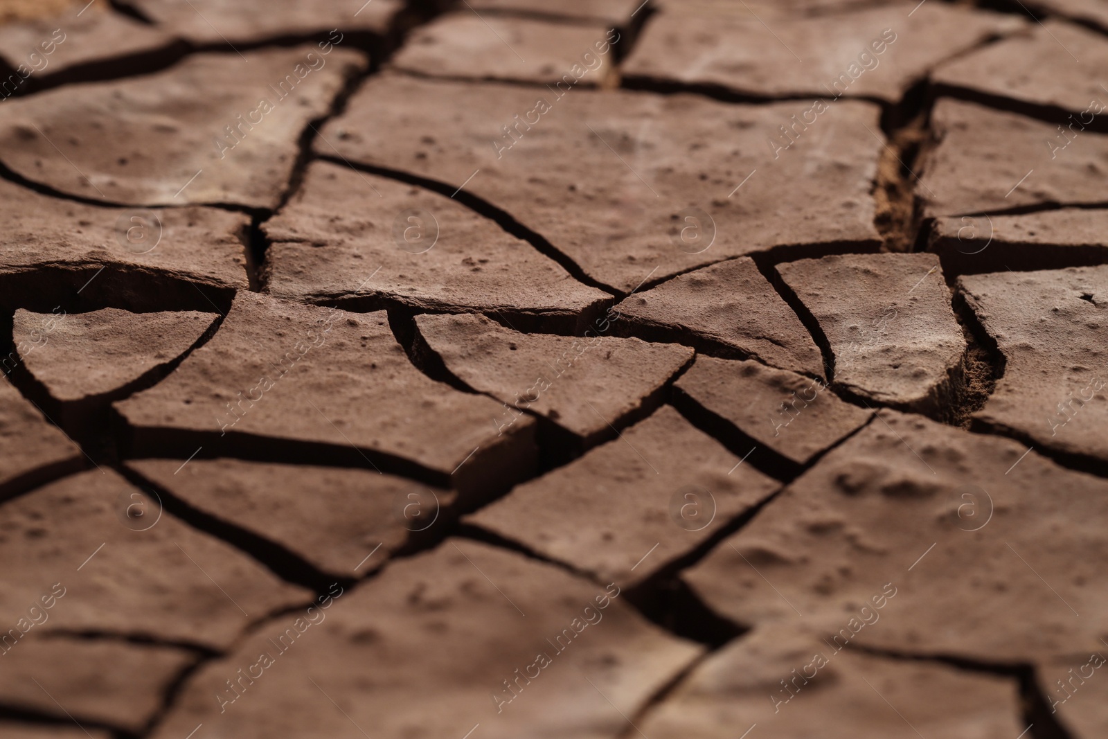 Photo of Dry cracked ground as background, closeup. Global warming