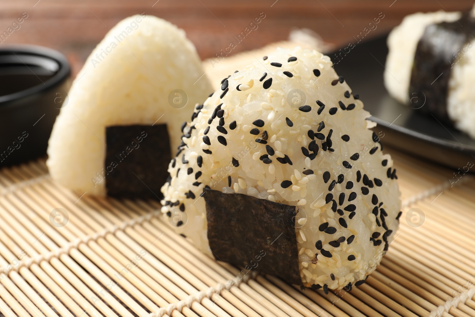 Photo of Rice balls (onigiri) on table, closeup. Traditional Japanese dish