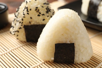 Photo of Rice balls (onigiri) on table, closeup. Traditional Japanese dish