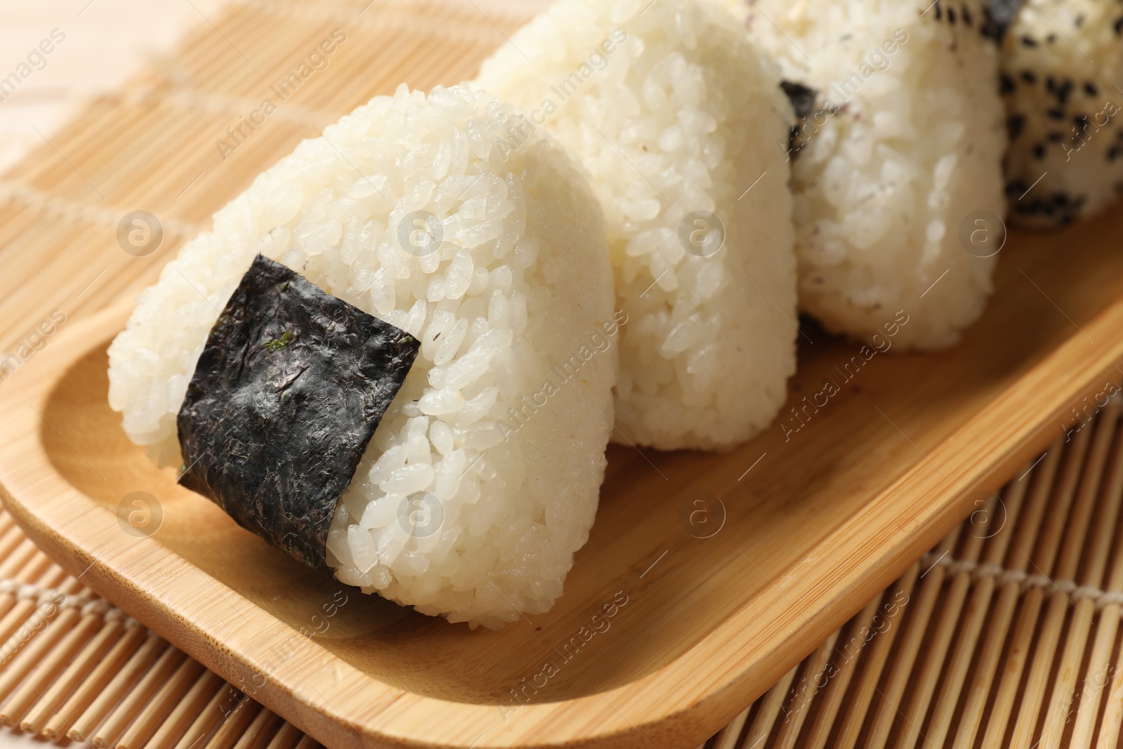 Photo of Rice balls (onigiri) on table, closeup. Traditional Japanese dish