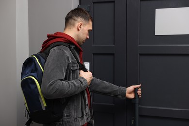 Photo of Man knocking on door of his friends apartment