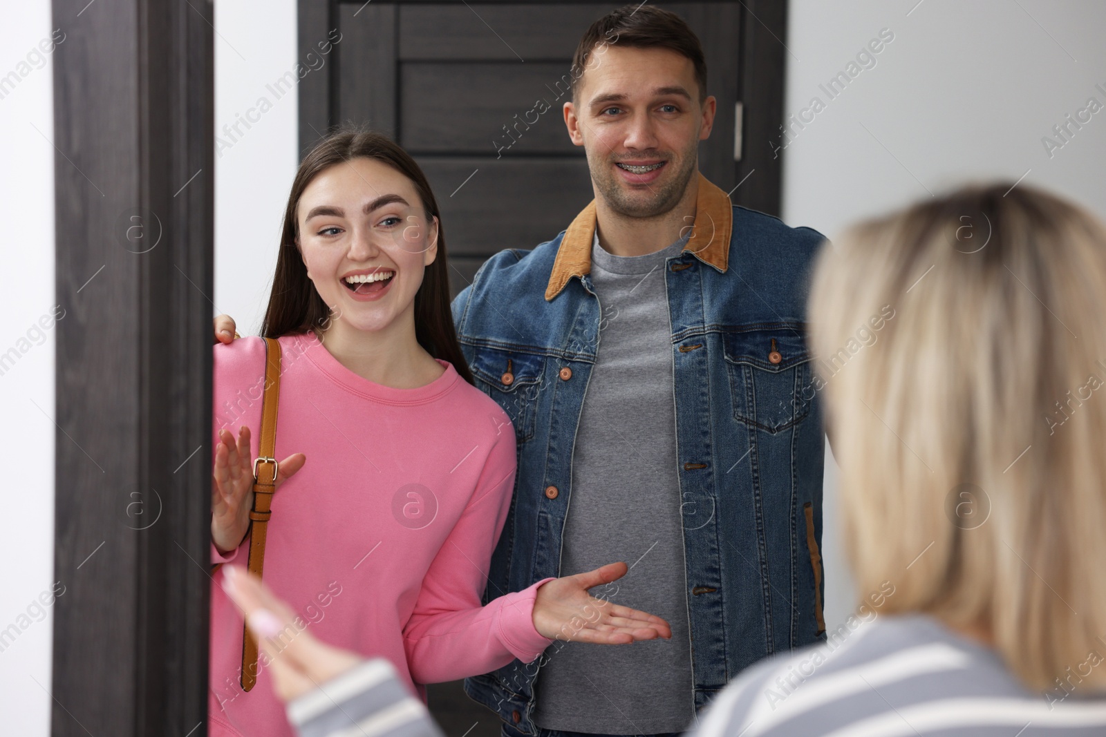 Photo of Woman welcoming new neighbors to her apartment