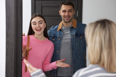 Photo of Woman welcoming new neighbors to her apartment