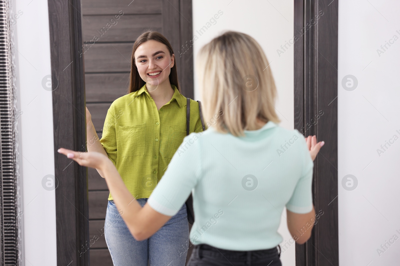 Photo of Woman welcoming new neighbor to her apartment