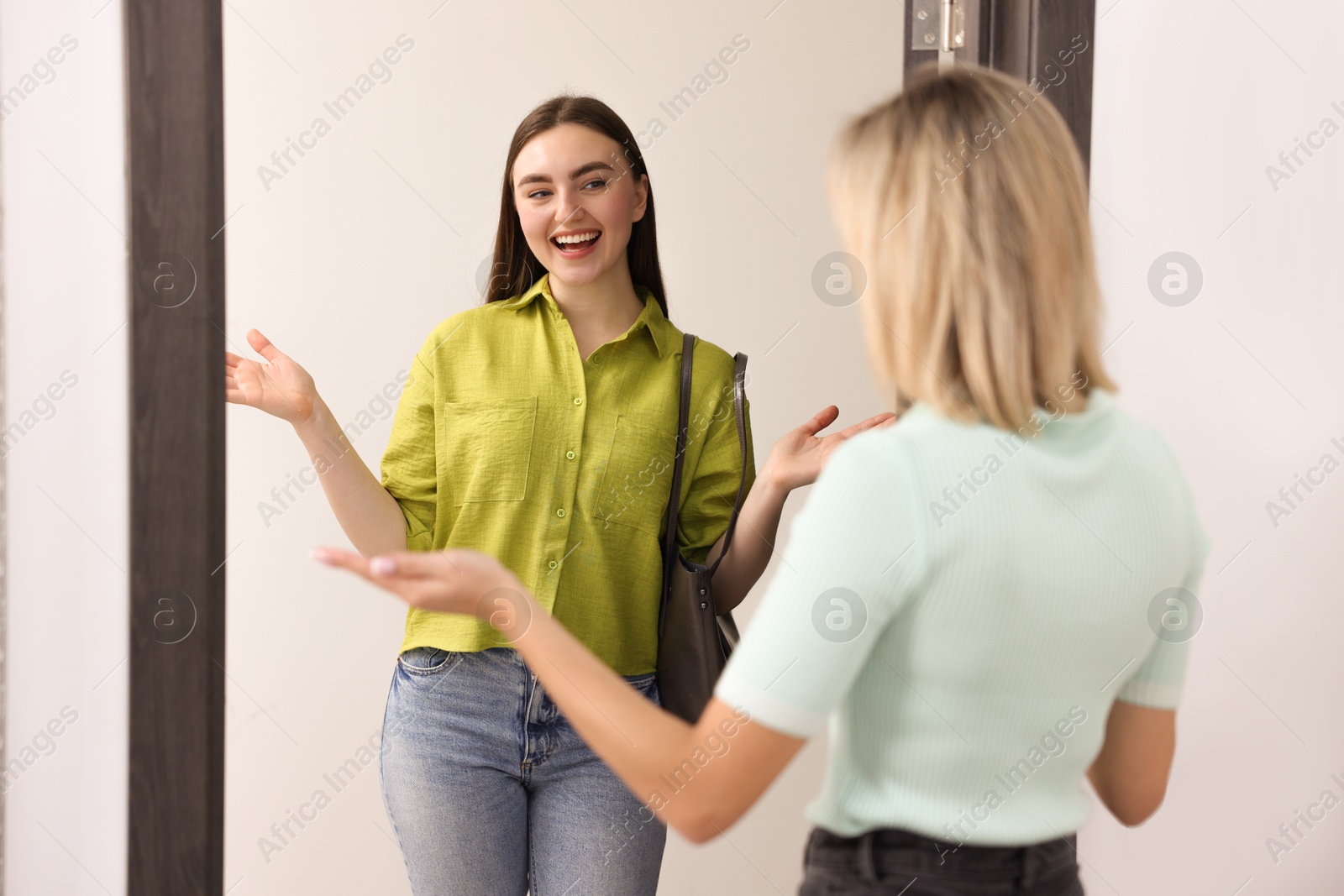 Photo of Woman welcoming new neighbor to her apartment