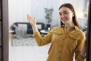 Photo of Happy woman welcoming friend to her house