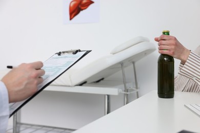 Photo of Alcoholic woman having appointment with healthcare specialist in clinic, closeup. Addiction treatment